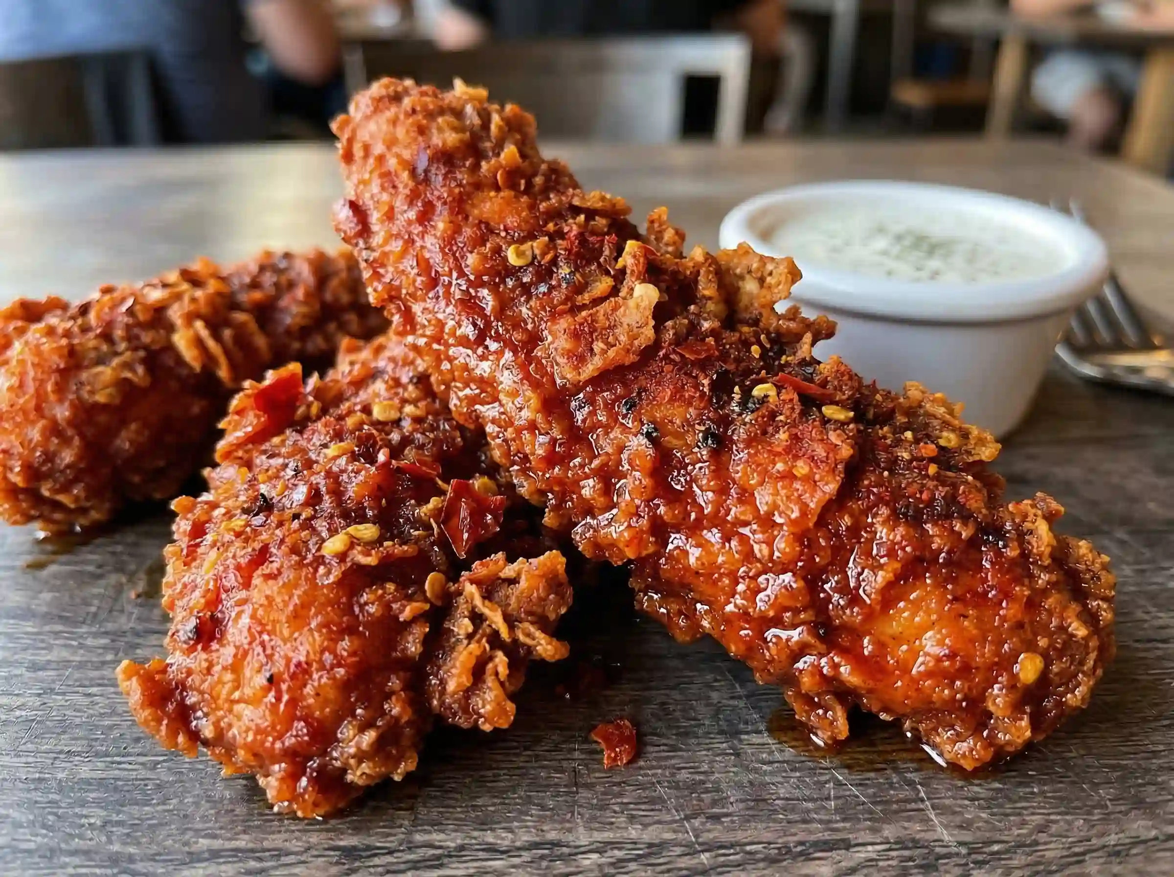 Close up of crispy KFC Nashville Hot Tenders with spicy cayenne seasoning